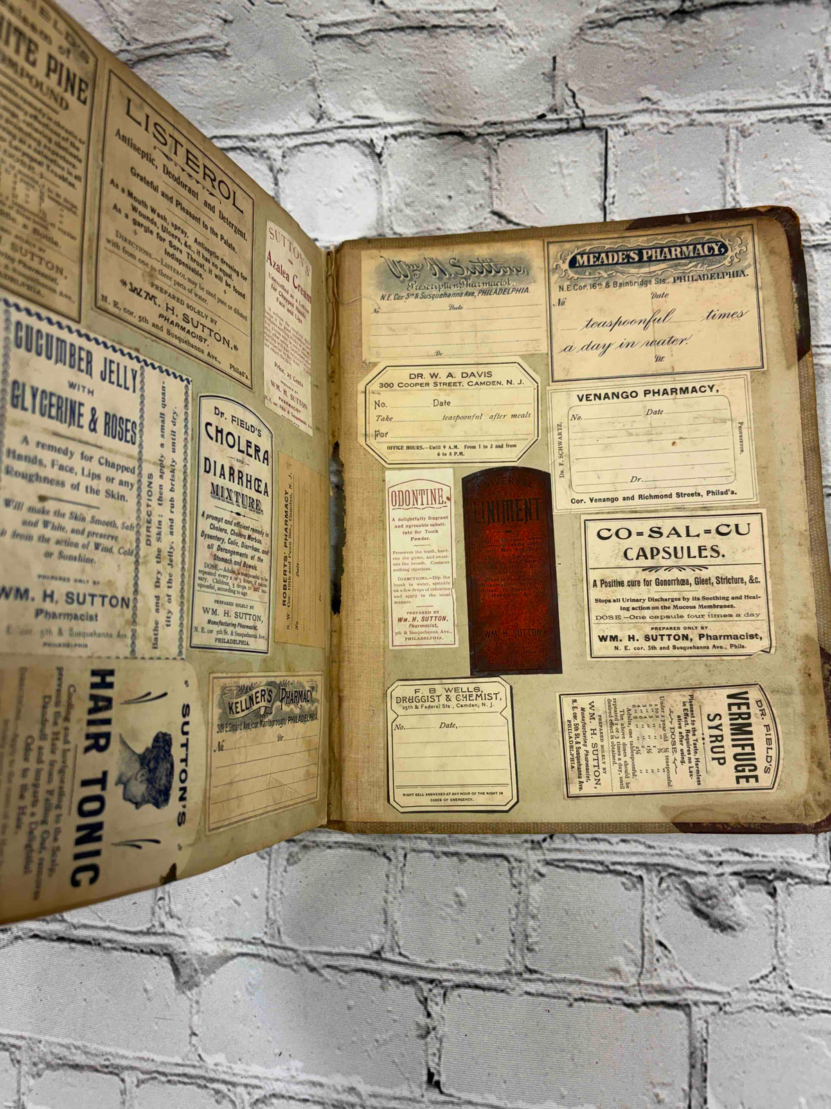 Pharmacist's handwritten formula book of Charles C. Neff, Ph.G., 1903-1906 - pasted-in pharmacy labels and advertisements