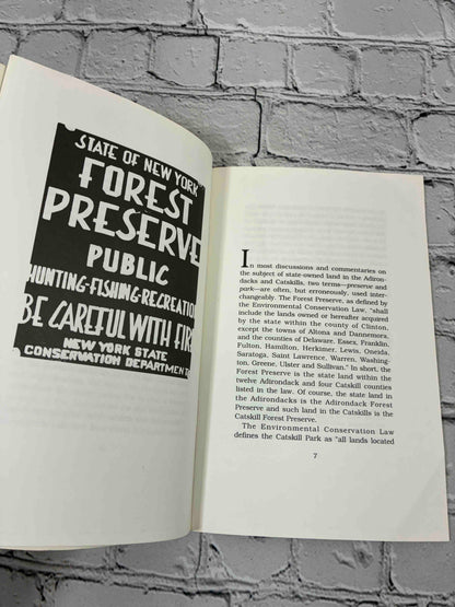 The Forest Preserve of New York State in the Adirondack and Catskill Mountains by Norman J. VanValkenburgh, 1996 Purple Mountain Press paperback - Forest Preserve sign photo and first page of text