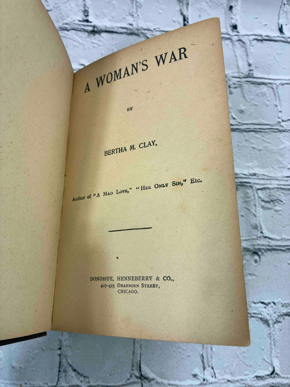 A Woman's War by Bertha M. Clay, Donohue Henneberry hardcover - title page