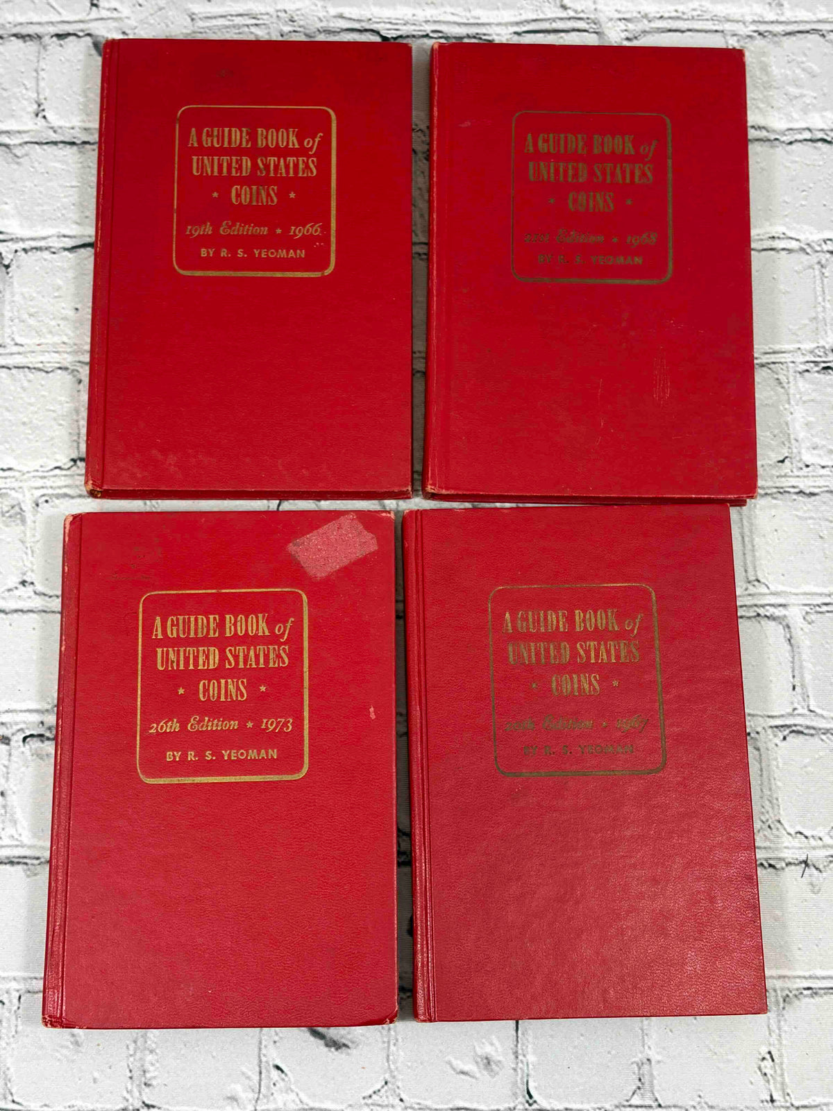 A Guide Book of United States Coins (Red Book) lot of 15 by R. S. Yeoman, 1961-1982 - front covers of 1966, 1968, 1973 and 1967 editions, tape residue on 1973 cover
