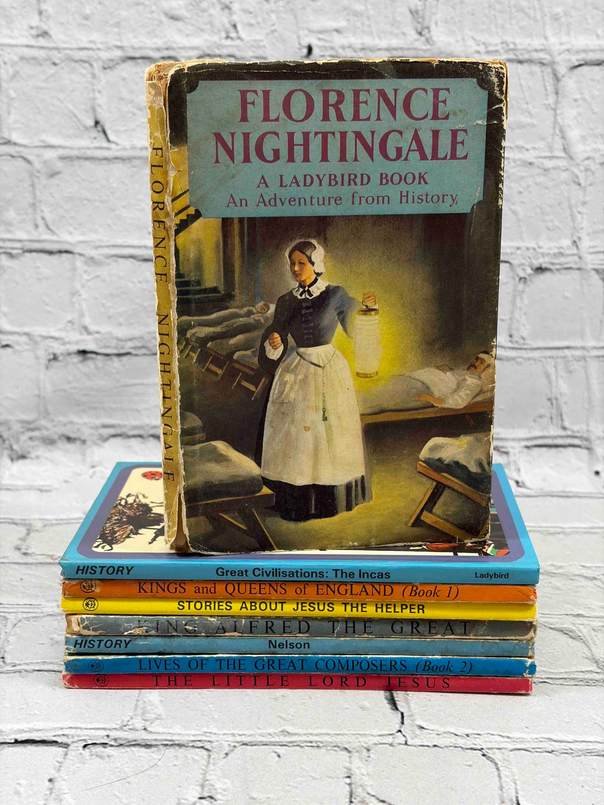 Lot of 8 vintage Ladybird books - stack showing spines