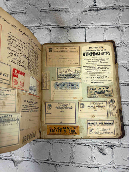 Pharmacist's handwritten formula book of Charles C. Neff, Ph.G., 1903-1906 - pasted-in pharmacy labels