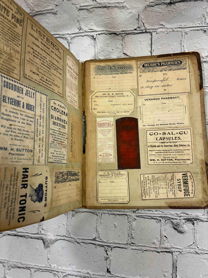 Pharmacist's handwritten formula book of Charles C. Neff, Ph.G., 1903-1906 - pasted-in pharmacy labels and advertisements