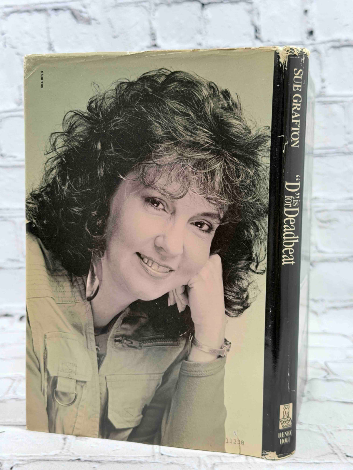 D Is for Deadbeat by Sue Grafton, 1987 Henry Holt hardcover - dust jacket rear and spine